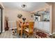 Cozy dining area with seating for six and a view of the kitchen at 500 Wekiva River Ct # 129, Englewood, FL 34223