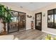 Bright Florida room featuring wood-look floors, sliding glass doors, and views into the home and the outdoors at 500 Wekiva River Ct # 129, Englewood, FL 34223