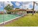 Community shuffleboard courts and picnic pavilion situated amongst palm trees and green lawns at 500 Wekiva River Ct # 129, Englewood, FL 34223