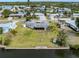 Aerial view of waterfront home with lush lawn and private dock at 504 Buena Vista Dr, Nokomis, FL 34275