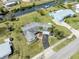 An aerial view of a waterfront property with lush landscaping, a private driveway, and canal access at 504 Buena Vista Dr, Nokomis, FL 34275