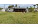 Spacious backyard with screen porch and established landscaping at 504 Buena Vista Dr, Nokomis, FL 34275