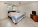 Cozy bedroom with a comfortable bed, ceiling fan, and natural light from the window at 504 Buena Vista Dr, Nokomis, FL 34275