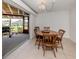 Dining room features tile floors, sliding doors to patio and charming chandelier at 504 Buena Vista Dr, Nokomis, FL 34275