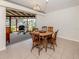 Cozy dining room with tile flooring, vintage chandelier, and access to an outdoor patio at 504 Buena Vista Dr, Nokomis, FL 34275