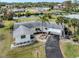 Aerial view of a charming single-story home with palm trees and a paved driveway at 504 Buena Vista Dr, Nokomis, FL 34275