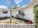 Inviting front entrance with well-maintained landscaping and a bright yellow door at 504 Buena Vista Dr, Nokomis, FL 34275