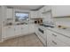 Bright kitchen with white cabinets, modern countertops, and stainless-steel appliances at 504 Buena Vista Dr, Nokomis, FL 34275