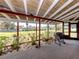 Screened lanai with a canal view, equipped with a grill, plants, and providing an ideal outdoor living space at 504 Buena Vista Dr, Nokomis, FL 34275