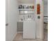 Functional laundry room with a washing machine, sink, and storage shelves at 504 Buena Vista Dr, Nokomis, FL 34275