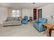 Comfortable living room featuring neutral walls, carpet flooring, and views of the front yard at 504 Buena Vista Dr, Nokomis, FL 34275