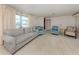 Comfortable living room featuring neutral walls, carpet flooring, and views of the front yard at 504 Buena Vista Dr, Nokomis, FL 34275