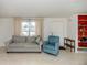 Comfortable living room featuring neutral walls, carpet flooring, and views of the front yard at 504 Buena Vista Dr, Nokomis, FL 34275