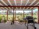 Covered patio with outdoor grill and view of the backyard at 504 Buena Vista Dr, Nokomis, FL 34275