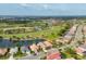 Stunning aerial shot of a golf course community, featuring a serene lake and lush green landscapes at 5223 Pine Shadow Ln, North Port, FL 34287