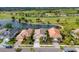 Panoramic aerial perspective of the golf course homes, highlighting the picturesque lake and sprawling greenery at 5223 Pine Shadow Ln, North Port, FL 34287