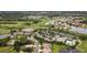 Expansive aerial view showcasing the community's golf course, tennis courts, pool, and residences at 5223 Pine Shadow Ln, North Port, FL 34287