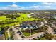 An aerial of golf course, a lake, community clubhouse, and manicured grounds at 5223 Pine Shadow Ln, North Port, FL 34287