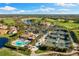 Aerial view of the community featuring golf course, clubhouse, pool and tennis courts at 5223 Pine Shadow Ln, North Port, FL 34287