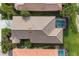 Aerial view of a well-maintained home with private screened-in pool, surrounded by lush green landscaping at 5223 Pine Shadow Ln, North Port, FL 34287