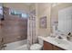 Well-lit bathroom featuring tub/shower combo and vanity with a sink at 5223 Pine Shadow Ln, North Port, FL 34287
