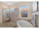 Bright and airy bathroom featuring soaking tub and glass enclosed shower at 5223 Pine Shadow Ln, North Port, FL 34287