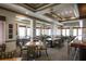 Clubhouse dining room with elegant tables, chairs, natural light and classic decor at 5223 Pine Shadow Ln, North Port, FL 34287