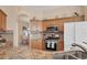 Well-equipped kitchen with stainless steel appliances and granite countertops offers a functional and stylish cooking space at 5223 Pine Shadow Ln, North Port, FL 34287