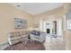 Inviting living room features tile flooring, large windows, and neutral decor at 5223 Pine Shadow Ln, North Port, FL 34287