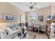Bright home office with a large window, desk, and comfortable seating at 5223 Pine Shadow Ln, North Port, FL 34287