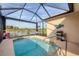 Screened-in pool overlooking a tranquil lake with golf course view, perfect for relaxation and outdoor enjoyment at 5223 Pine Shadow Ln, North Port, FL 34287