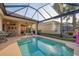 Inviting screened-in pool with outdoor living area and lush landscaping for enjoying Florida's sunshine at 5223 Pine Shadow Ln, North Port, FL 34287
