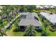 Aerial view showcases the home's tile roof, screened pool, and lush landscaping at 525 Cheval Dr, Venice, FL 34292