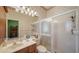 Bathroom with a walk-in shower, sink and vanity with storage and neutral colored walls at 525 Cheval Dr, Venice, FL 34292