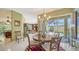An airy dining room open to the living area with views to the pool at 525 Cheval Dr, Venice, FL 34292