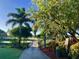 Scenic golf course view featuring a wooden bridge, lush greenery, and mature trees at 525 Cheval Dr, Venice, FL 34292