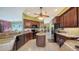 Kitchen with stainless steel appliances, a kitchen island, tile floors, and cherry wood colored cabinets at 525 Cheval Dr, Venice, FL 34292