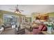 Comfortable living room with plush seating, a ceiling fan, and views of the lanai and pool area at 525 Cheval Dr, Venice, FL 34292