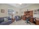 Inviting home office with couches, built-in desk, and a large window for natural light at 525 Cheval Dr, Venice, FL 34292