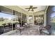 Relaxing patio with comfortable wicker seating, offering serene golf course views at 525 Cheval Dr, Venice, FL 34292