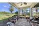Spacious screened lanai with cozy seating and serene views of the lush green landscape at 525 Cheval Dr, Venice, FL 34292