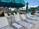 Inviting pool deck with lounge chairs and umbrellas, perfect for relaxation at 525 Cheval Dr, Venice, FL 34292