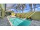 Inviting screened-in pool area with a sparkling pool, patio, and beautifully landscaped garden at 525 Cheval Dr, Venice, FL 34292