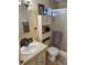 Well-lit bathroom with a sink, toilet, cabinet, and shower with sliding glass doors at 533 Cervina N Dr # 773, Venice, FL 34285