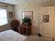 Bright bedroom displaying a side table, indoor plant, and carpeted floors at 533 Cervina N Dr # 773, Venice, FL 34285