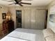 Comfortable bedroom showcasing a bed, dresser, closet, and connected bathroom at 533 Cervina N Dr # 773, Venice, FL 34285