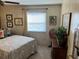 Cozy bedroom featuring a paisley bedspread, neutral walls, and wood furnishings at 533 Cervina N Dr # 773, Venice, FL 34285
