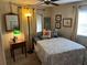 Cozy bedroom features a bed, a small table and decor at 533 Cervina N Dr # 773, Venice, FL 34285