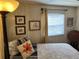 Inviting bedroom features a patterned bedspread, floral pillows, and wood accents at 533 Cervina N Dr # 773, Venice, FL 34285