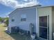 View of the side of the home featuring an air conditioning unit and a screened-in porch at 533 Cervina N Dr # 773, Venice, FL 34285